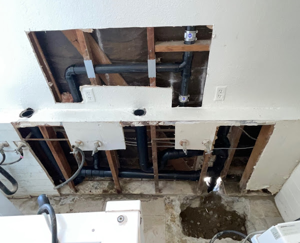 Professional drain and repipe installation inside a wall